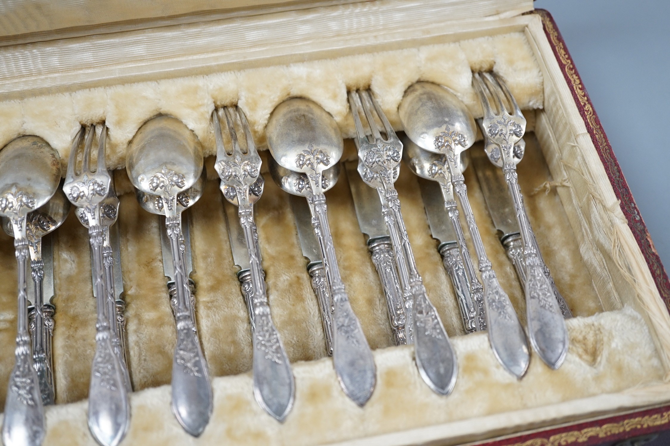 An early 20th century cased set of twelve French 950 standard white metal tea knives, spoons and forks, by Henin & Vivier and Henin & Cie?, retailed by Charles Pellegrin, spoon 14.1cm, 20oz.